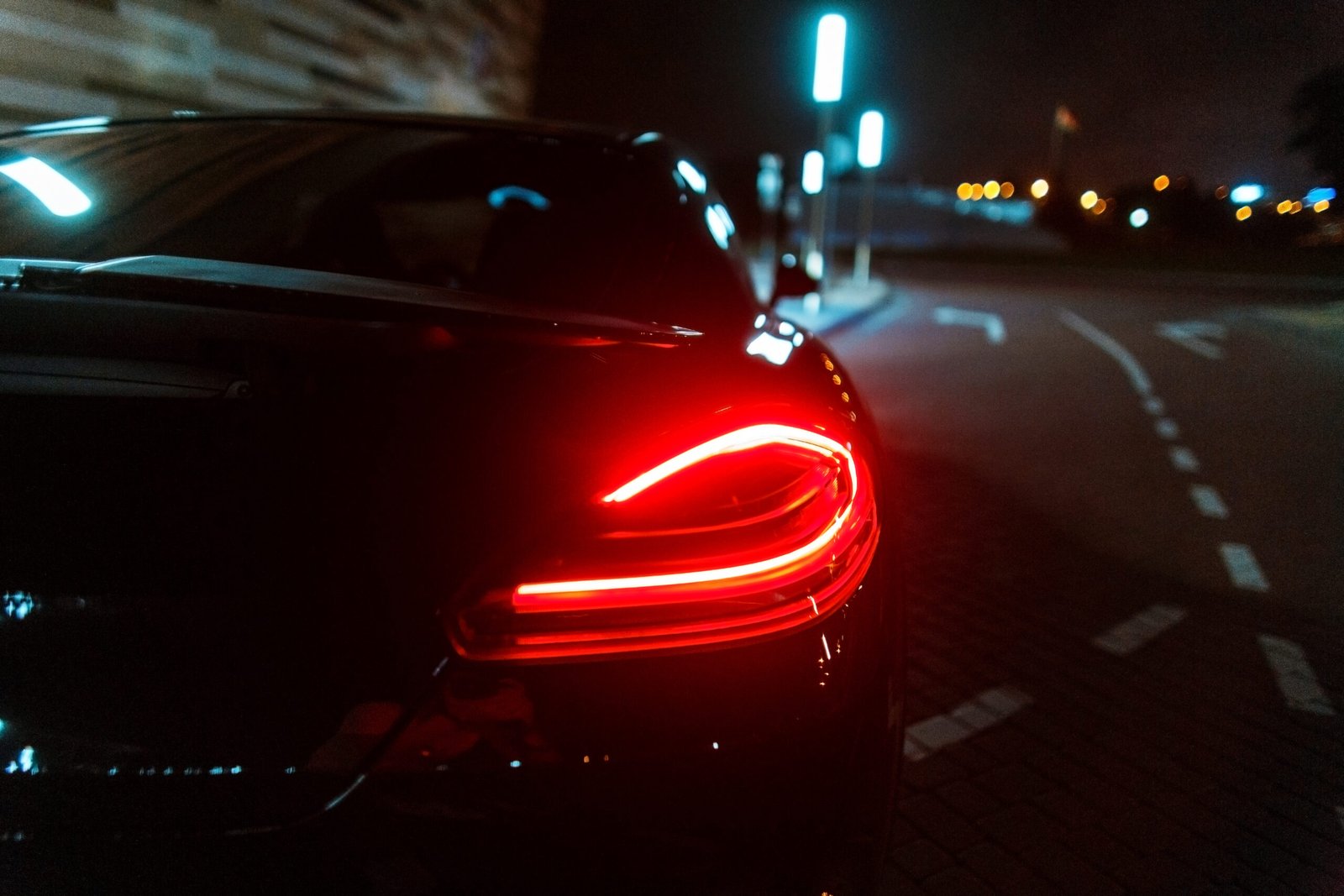 Modern luxury black car with stop lamp at night